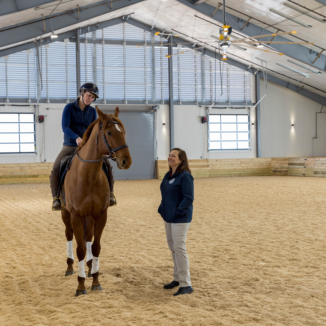 Hannah Schofield rides her horse Merry under the watchful eye of Jennifer Barrett, Theodor Ayer Randolph professor of equine surgery during a soundness evaluation.